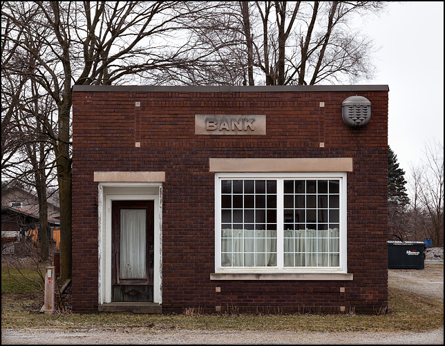A tiny brick bank building sits abandoned on County Road 142 in the small crossroads town of Foraker, Indiana.