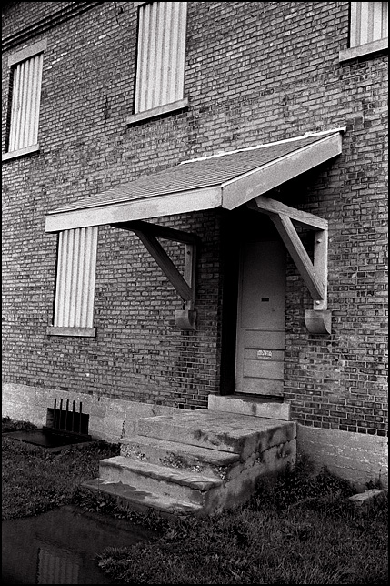 The boarded up windows and door on the entrance to the old brick New York Central Railroad Freight House on Clinton Street in Fort Wayne.