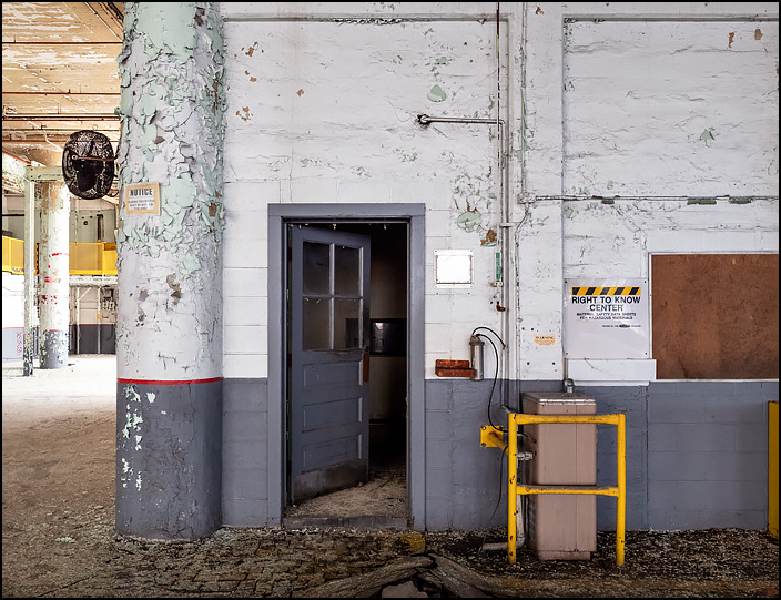 The door to an office on the first floor of building 19 at the former General Electric factory complex in Fort Wayne, Indiana. A sign on the wall says it is a Right To Know Center, where MSDS are kept. A drinking fountain stands by the door.