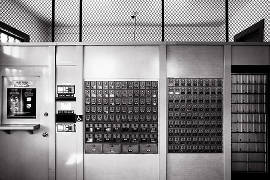 Black and white photograph of the interior of the small post office in the village of Glorieta, New Mexico.