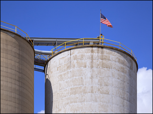 An American flag flies from the top of a huge concrete silo at Hicksville Grain in the small town of Hicksville, Ohio.