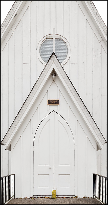 The front doors of the historic Saint Pauls Episcopal Church, a white carpenter gothic style church built in 1875 in the small town of Hicksville, Ohio.