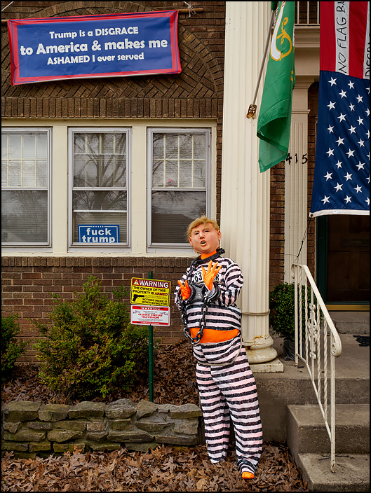 An effigy of President Donald Trump wearing a striped prison uniform and shackles stands in front of a house on Oakdale Drive in Fort Wayne, Indiana. Signs in the windows say Fuck Trump, and a banner declares that Trump is a disgrace to America.