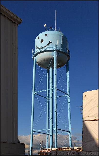 A blue water tower with a smiley face in the small town of Markle, Indiana.