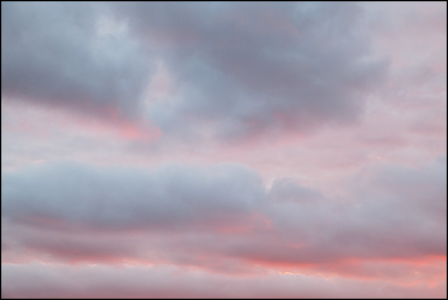 Abstract photograph of clouds against a purple and pink sunset sky in rural Elkhart County, Indiana.