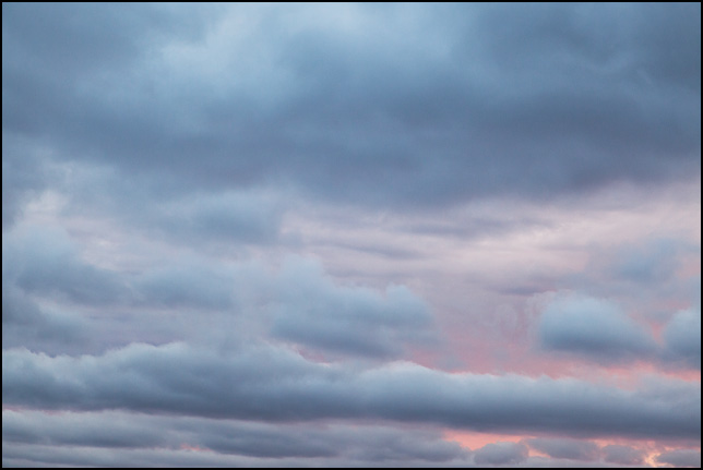 Abstract photograph of blue clouds against a pink sunset sky in rural Elkhart County, Indiana.