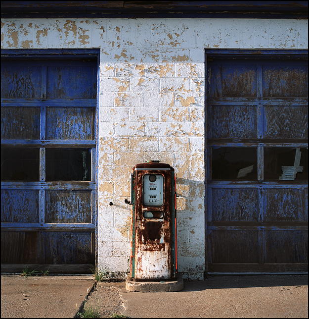 A rusty old Tokheim gas pump sits in front of an abandoned service station on Route 66 in McLean, Texas.