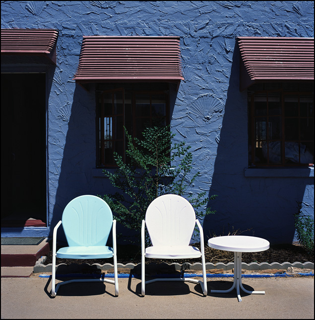 A pair of metal lawn chairs outside a room at the Blue Swallow Motel on Route 66 in Tucamcari, New Mexico.