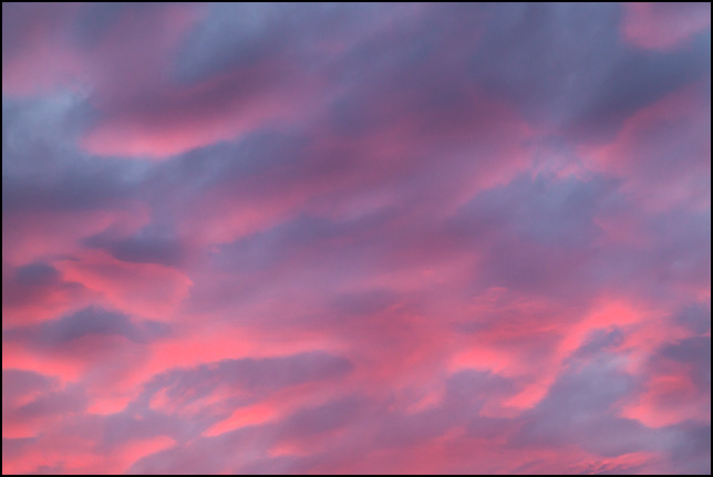 Abstract photograph of red and purple clouds in a vivid blue sky on a November evening in rural Allen County, Indiana.