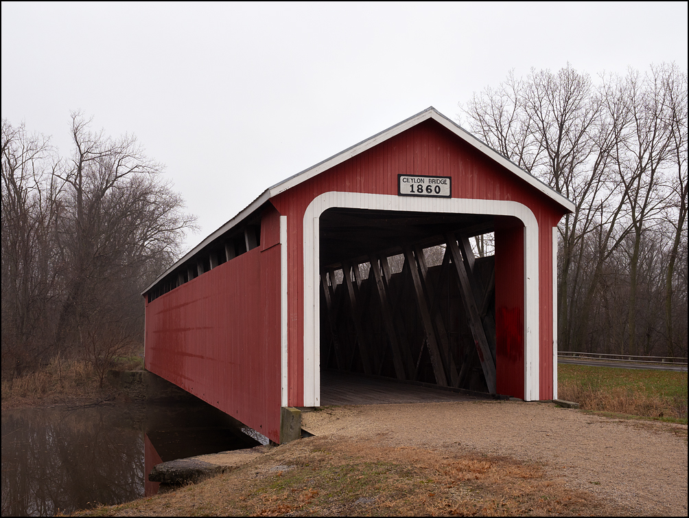 Ceylon Covered Bridge, a red wooden covered bridge built in 1879 on the Wabash River in rural Adams County, Indiana. It is just north of the towns of Geneva and Ceylon.