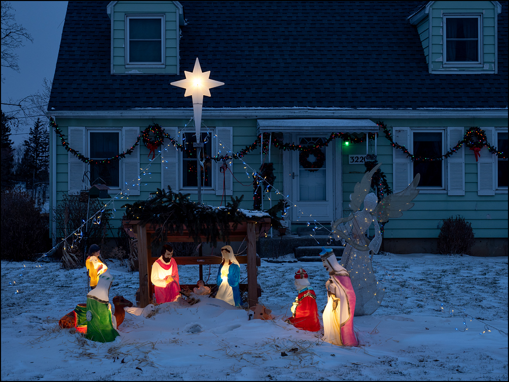 A nativity scene with a large plastic star and lighted biblical figures in front of a house on Sandpoint Road in Fort Wayne, Indiana. Photographed very early in the morning just before the sun rose.