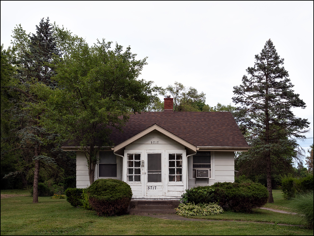 A small white house with a small windowed entryway on Arbor Avenue in Fort Wayne, Indiana.