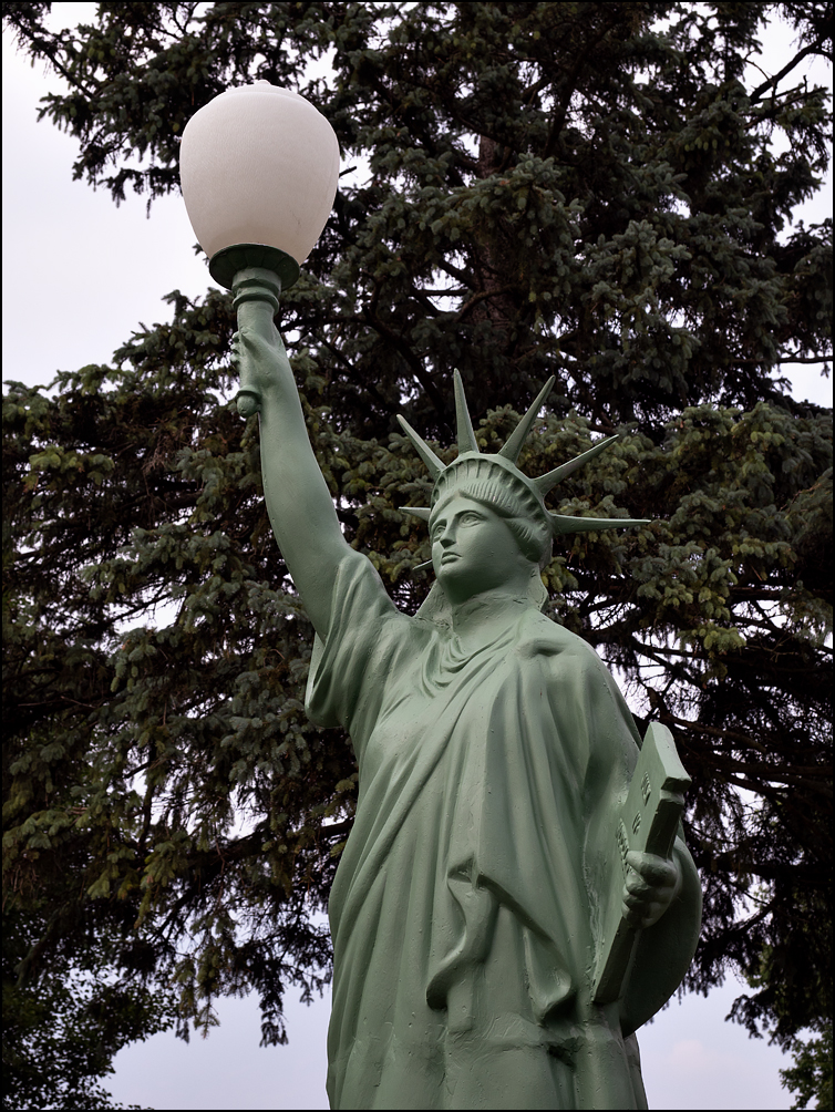 A Statue of Liberty yard light in the small town of Ossian, Indiana. Made of cast aluminum by Tuscumbia Iron Works.