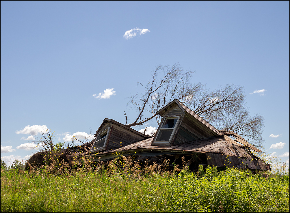 The nearly intact roof of an demolished farmhouse lay on the ground where the house once stood on Lower Huntington Road in rural Allen County, Indiana.