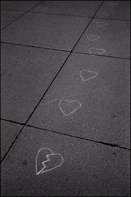A sidewalk covered in chalk drawings of broken hearts as an anti-abortion pro-life protest.