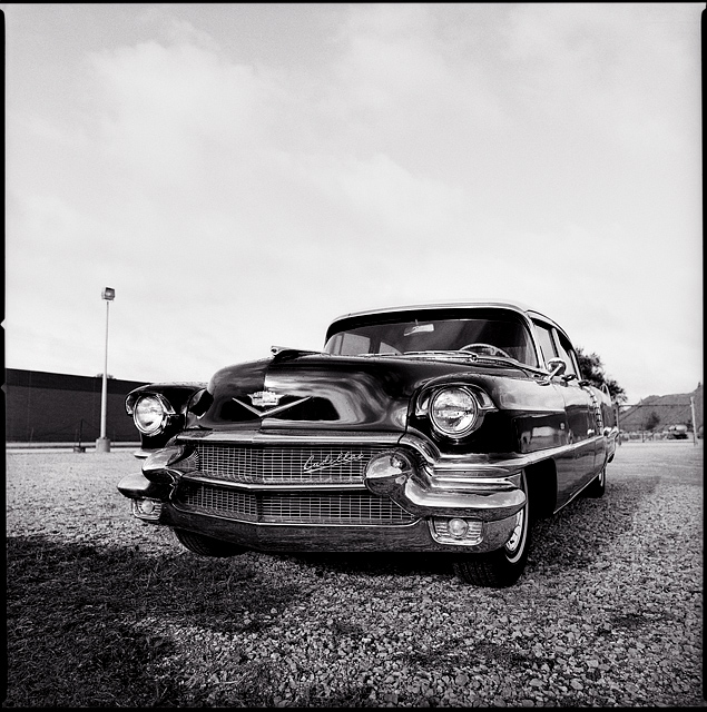 A 1956 Cadillac sedan parked on the gravel lot in front of a trucking company on Ardmore Avenue in Fort Wayne, Indiana.