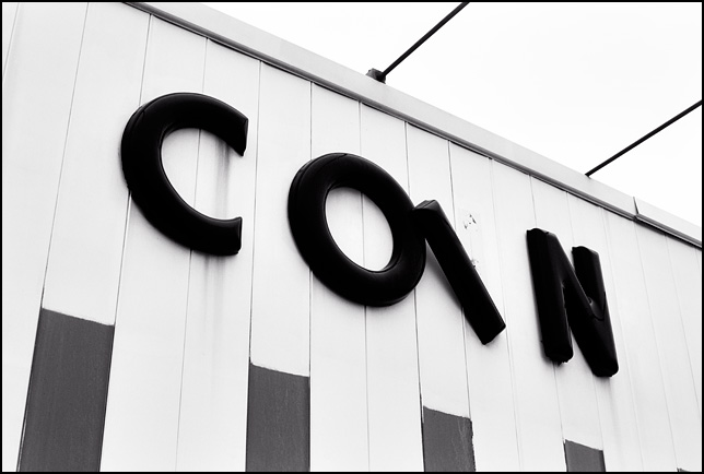 A sign that says COIN on the front of an abandoned laundromat on Paulding Road in Fort Wayne, Indiana.