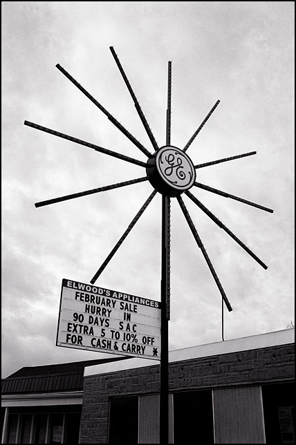 The starburst shaped General Electric sign outside Elwoods Appliances in the Waynedale area of Fort Wayne, Indiana. The sign has hundreds of tiny bulbs radiating out from the center with a lighted GE logo.