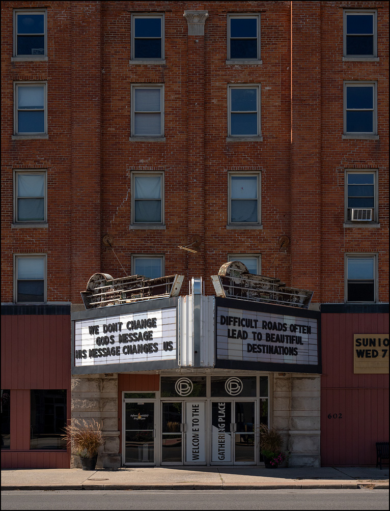 The Gathering Place, a non-denominational Christian church in a former theatre on Clinton Street in the small town of Defiance, Ohio. The marquee says, We don't change Gods message - His message changes us. Difficult roads often lead to beautiful destinations.