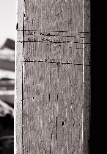 A child's growth recorded in markings on the wooden door frame in my grandfather's kitchen.