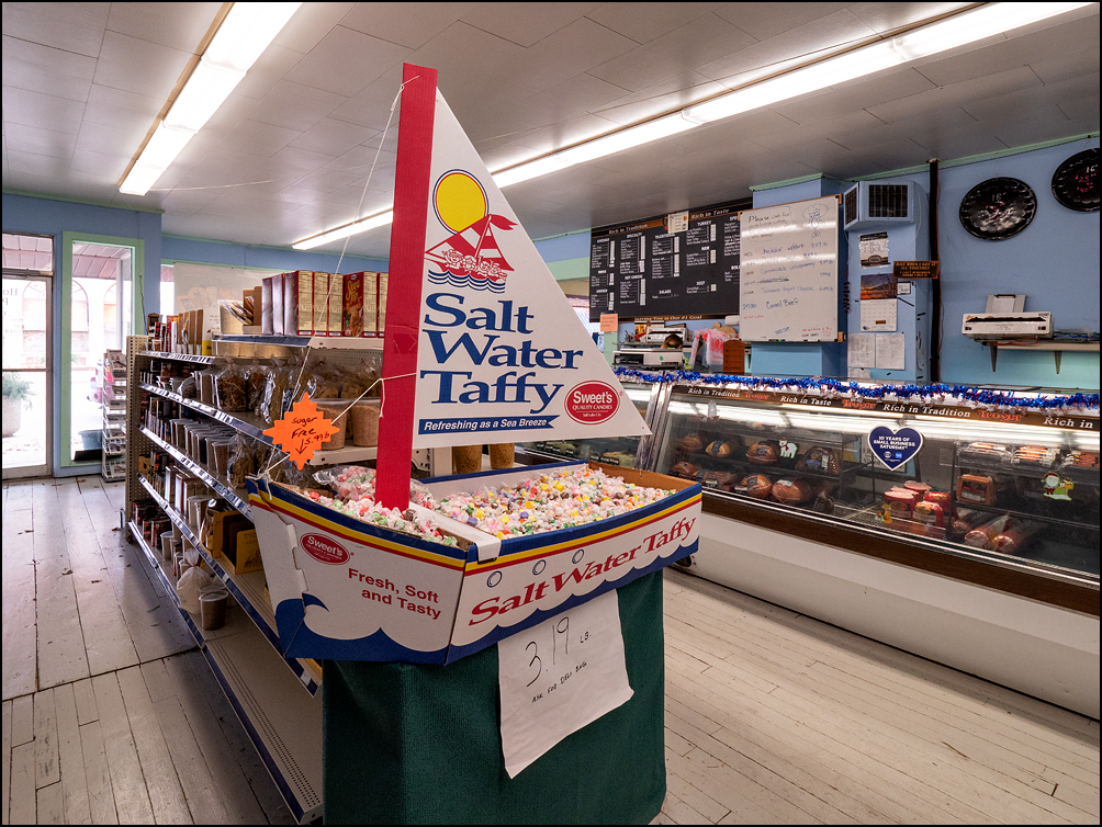 A cardboard sailboat full of salt water taffy on display at the end of an aisle at Hometown Pantry, a small locally-owned grocery store on Main Street in the small town of Antwerp, Ohio. The deli counter is visible in the background.