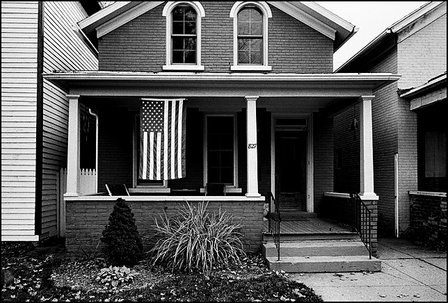 An American flag on the front porch of an old Victorian house in the historic West Central neighborhood in Fort Wayne, Indiana.