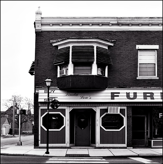 The front of a former tavern that is now Linda Lou's Furniture in an old brick building on Wells Street in Fort Wayne, Indiana.