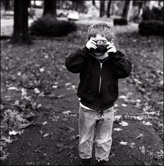 My four year old son takes a picture with a Canon Sure Shot Owl 35mm point and shoot camera.