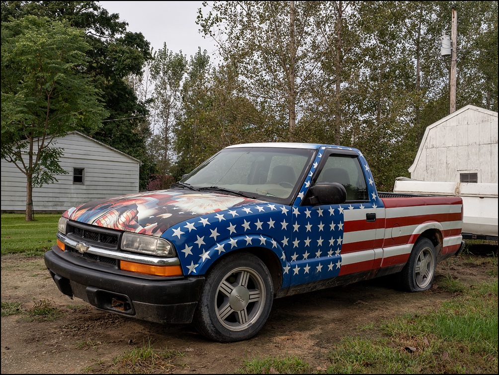 A Chevrolet S-10 pickup truck painted like an American flag in the small town of Maples, Indiana. The hood is covered by a picture of a bald eagle.