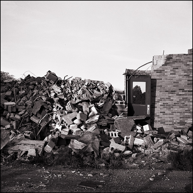 A door stands in a pile of rubble at the end of a demolished brick wall at Pleasant Center Elementary School outside Fort Wayne, Indiana.