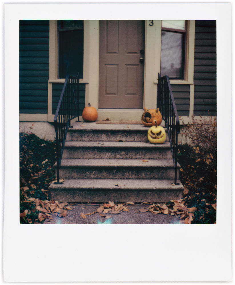 Polaroid snapshot of a house decorated for Halloween with jack-o-lanterns on the doorsteps in the West Central neighborhood in Fort Wayne, Indiana.