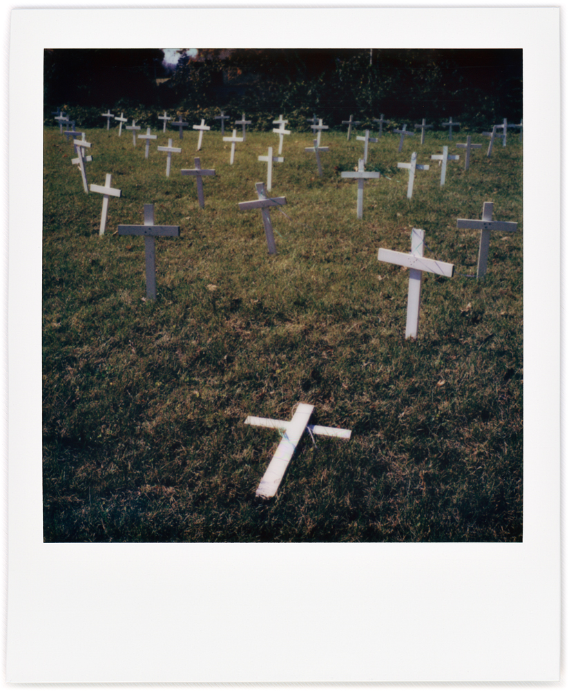 Polaroid snapshot of white wooden crosses filling a vacant lot to protest abortion next to New Life Lutheran Church on South Coliseum Boulevard in Fort Wayne, Indiana.
