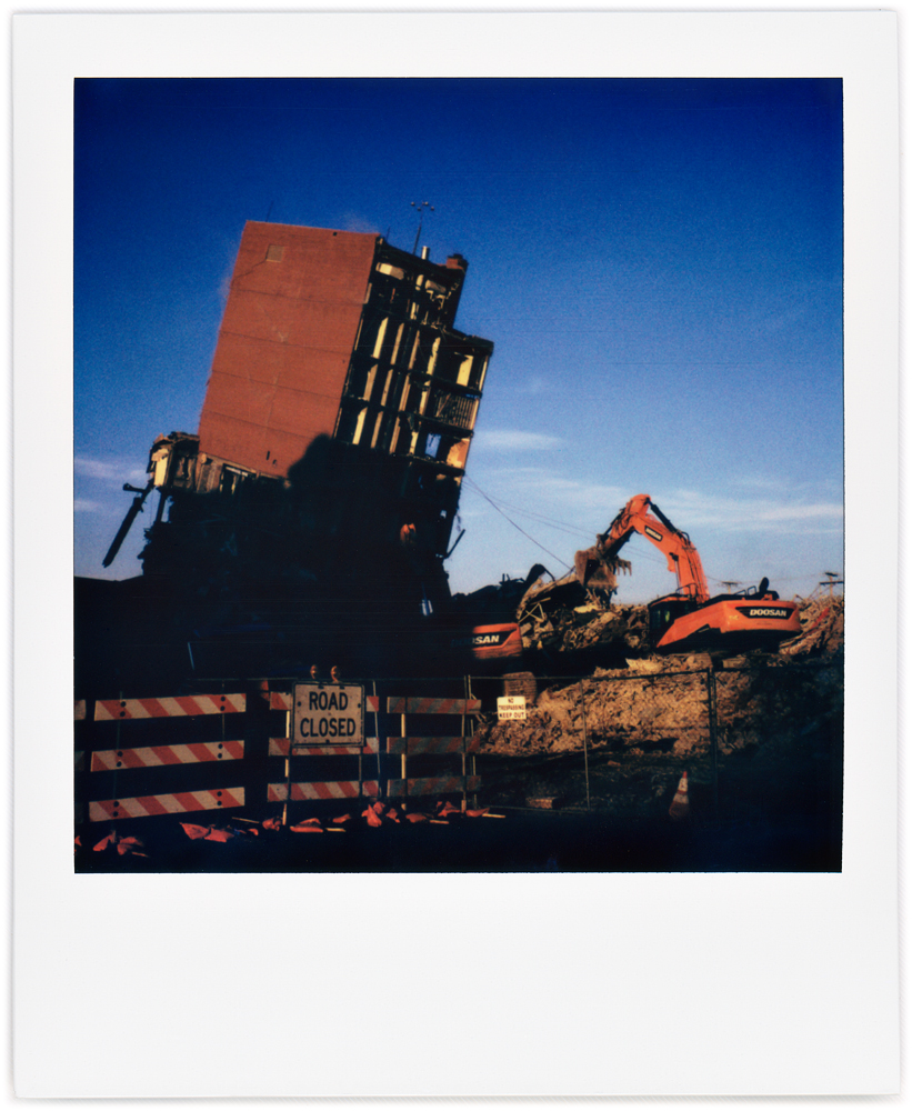 Polaroid photo of the last remaining part of Saint Joseph Hospital collapsing as excavators pull it down with steel cables. The hospital was on Broadway in downtown Fort Wayne, Indiana.