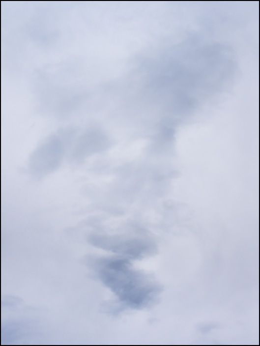 An abstract photograph of clouds forming a triangular shape in the evening sky in rural northwest Allen County, Indiana.
