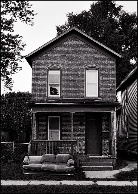 A sofa in the front yard of an old brick house on Fourth Street in Fort Wayne, Indiana.