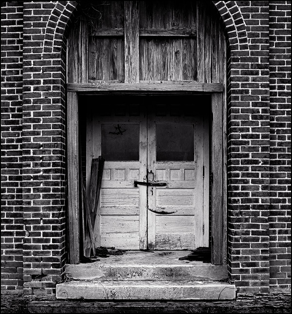 The double wooden doors in the front of the abandoned Jefferson Township District 4 Schoolhouse in Wells County, Indiana.