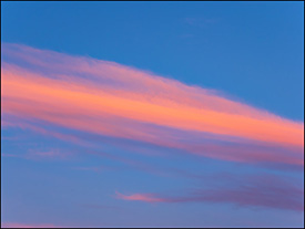 Abstract photographs of an orange and red cloud in the sky at sunrise on a June morning in Indiana.