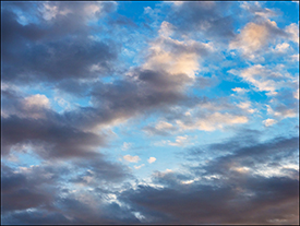 Abstract photographs of dark clouds and white clouds together in a blue July morning sky in Fort Wayne, Indiana.