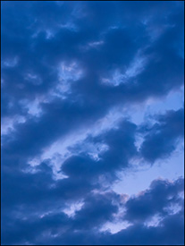 Abstract photograph of lines of purple clouds in the sky at sunset on a July evening in Fort Wayne, Indiana.